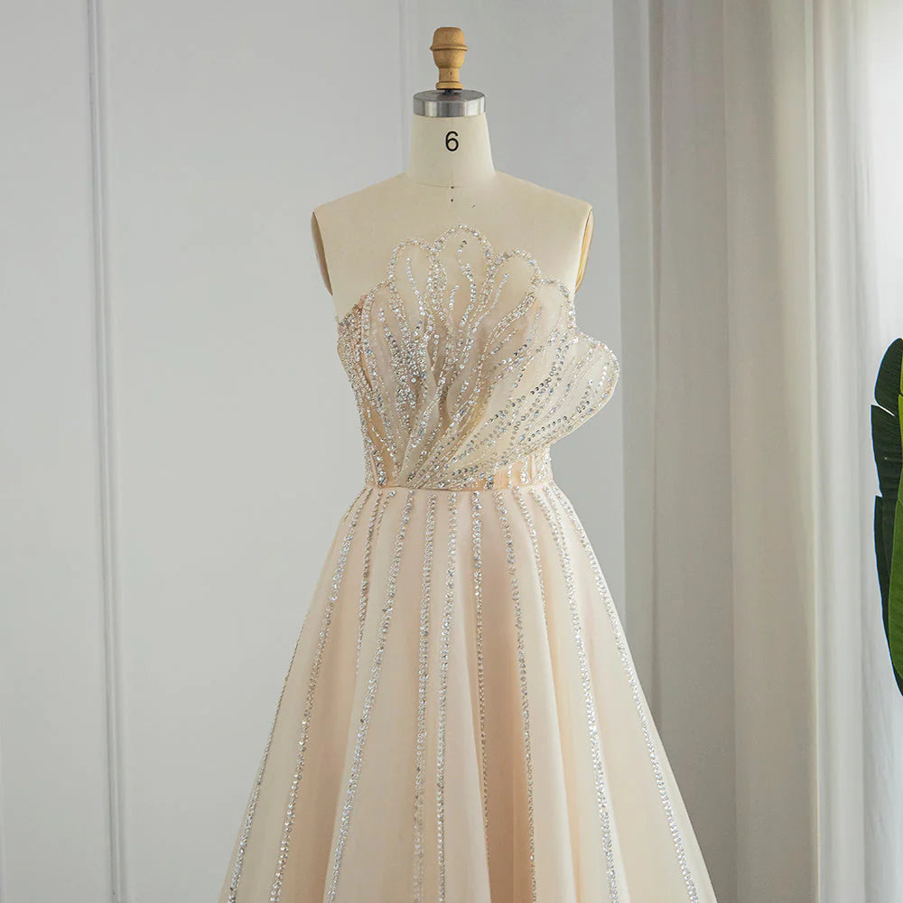 فستان راقي بتصميم بتلات ورد متموجه ومطرزه بطابع أنثوي