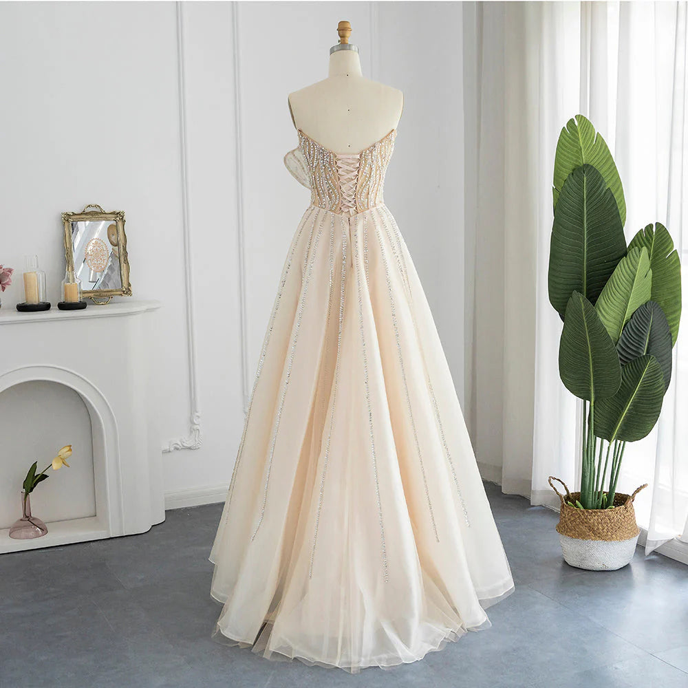 فستان راقي بتصميم بتلات ورد متموجه ومطرزه بطابع أنثوي